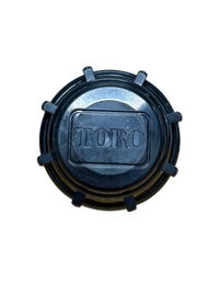 Close-up view of Toro 570 blank shut-off cap showing top profile, sealing surface, and fitment area for 570 pop-up sprinkler bodies (front view).