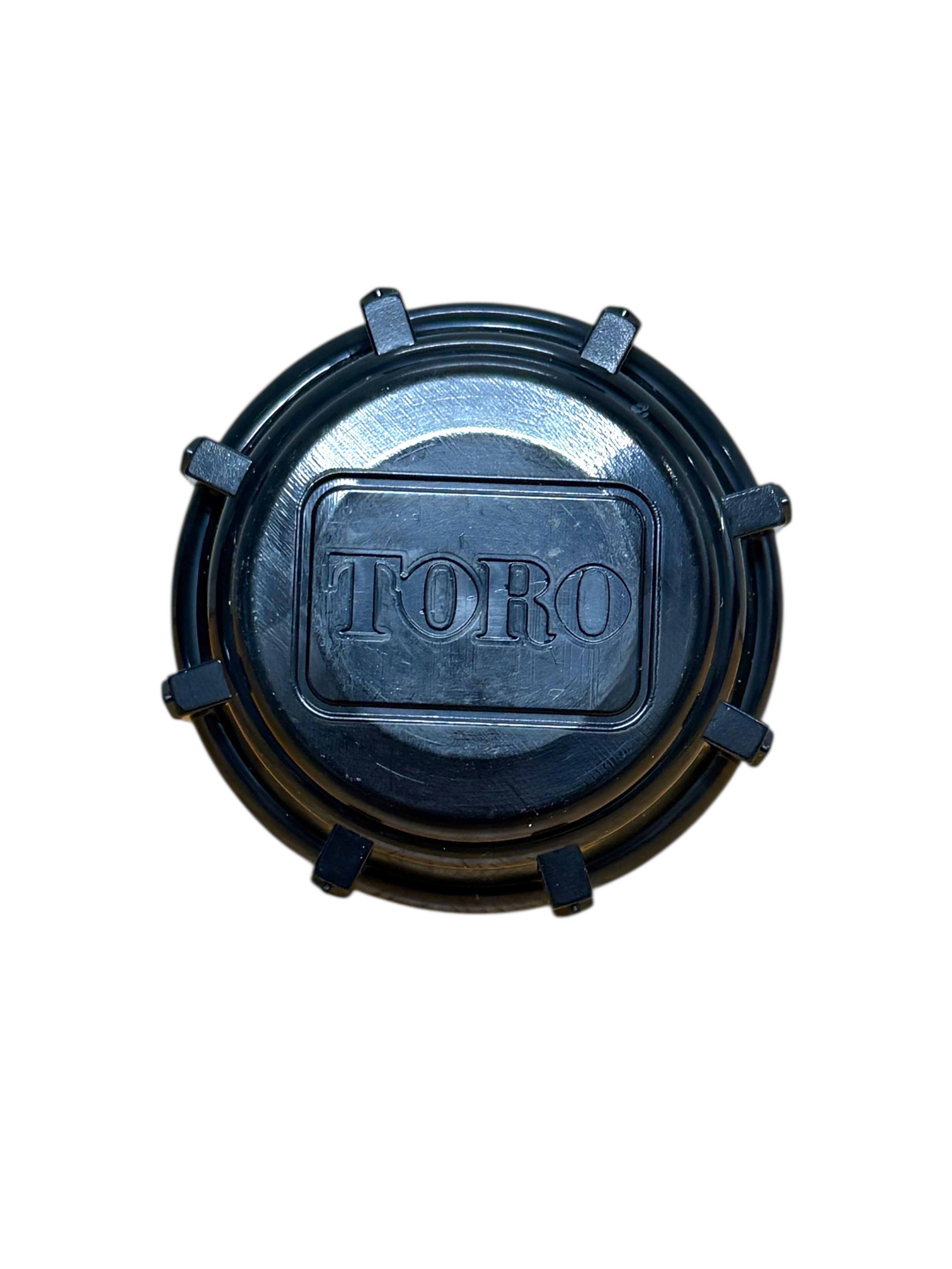 Close-up view of Toro 570 blank shut-off cap showing top profile, sealing surface, and fitment area for 570 pop-up sprinkler bodies (front view).