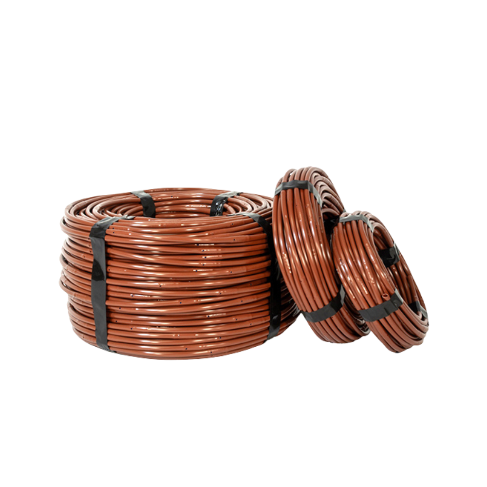 Close-up of brown Microline 1/4 in. dripline highlighting built-in emitters and large internal filter design to reduce clogging.