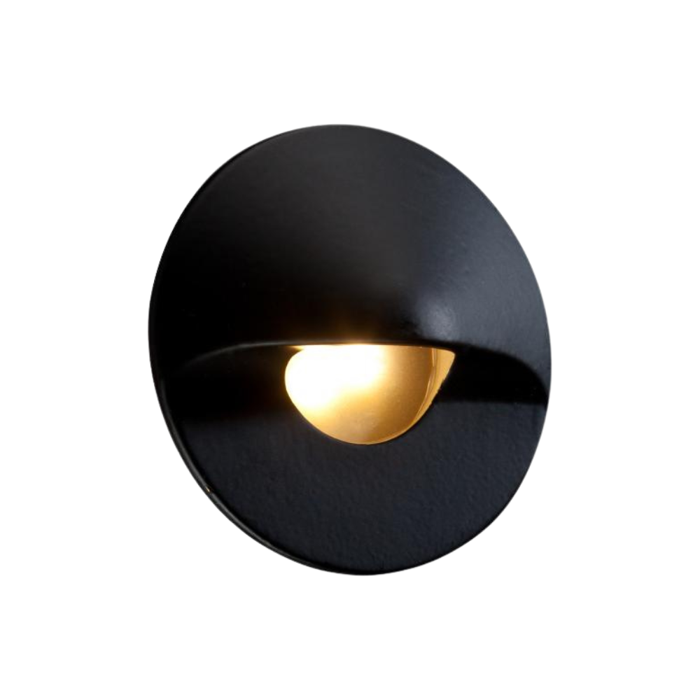 Studio image of FX MO round hardscape LED wall light finished in flat black, showing mounting profile, frosted lens, and compact round housing.