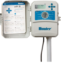 Hunter X2 model X2400 shown with open terminal area and labeled station connections, useful for installers checking wiring during setup.