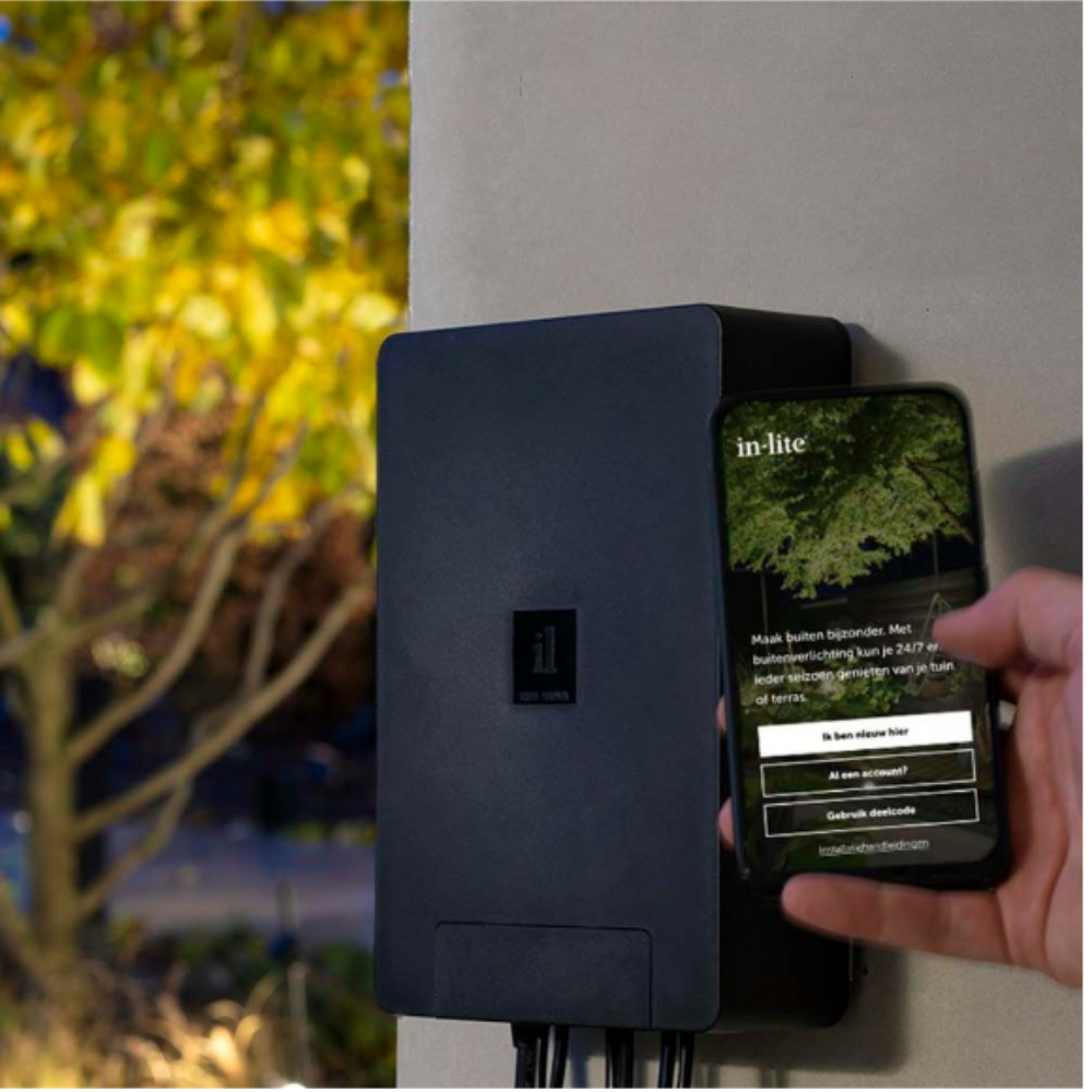 SMART HUB-150 installed example showing transformer mounted vertically with visible mounting screws and cable outputs for landscape lighting.