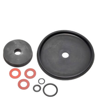 Superior 950 Series electric valve repair kit components laid out: diaphragm, flow-control o-ring, disk seat, and stem washers (kit view)