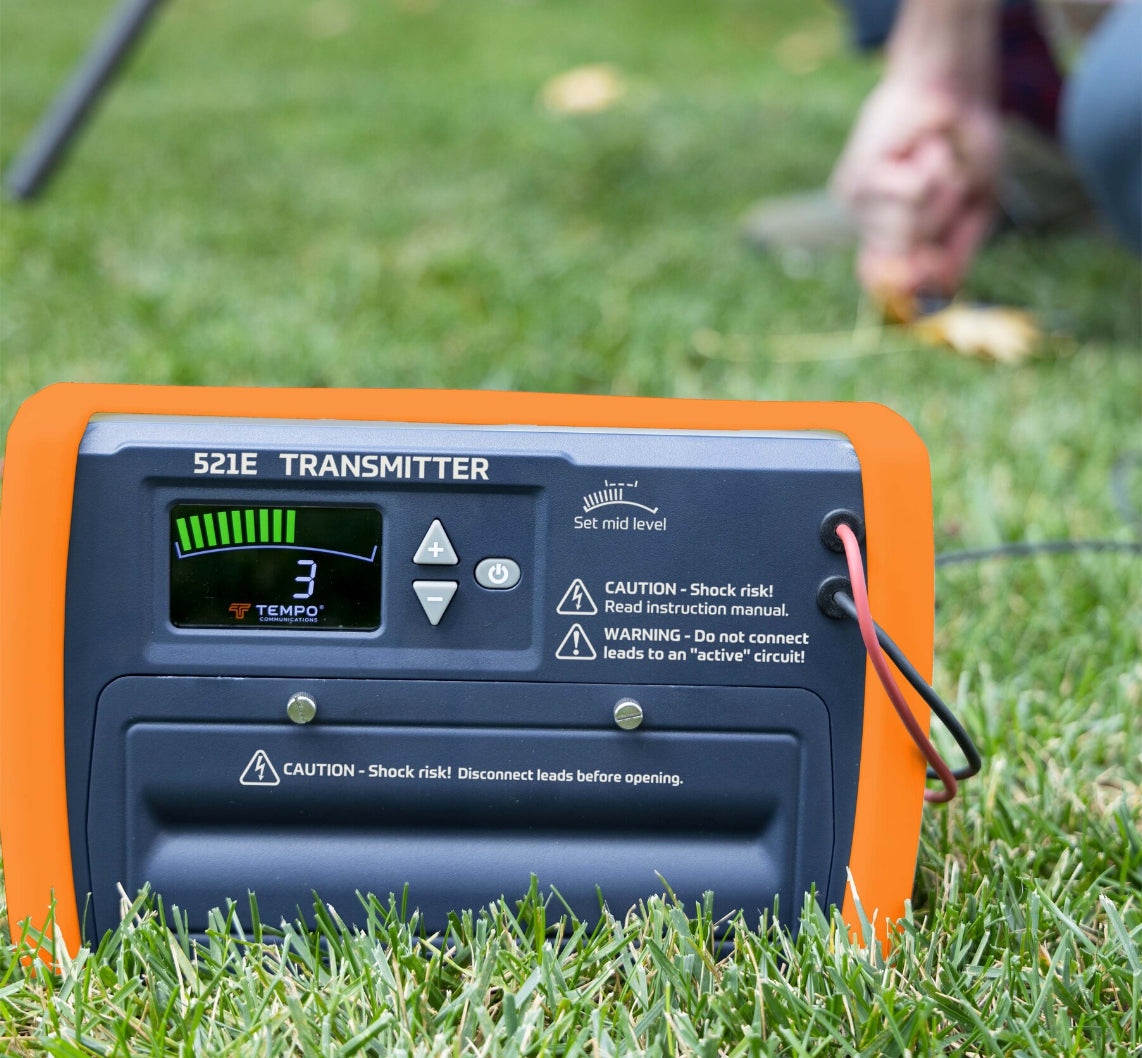 Angled view of the Tempo 521E receiver tracking a buried wire path, highlighting the 45° angle detector and clear null/peak indicators on the display.