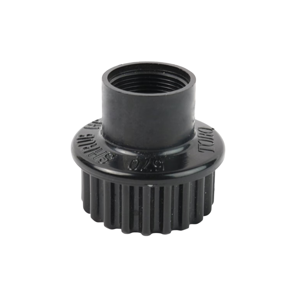Close-up of Toro 570S shrub adapter showing 1/2 in female threaded inlet and molded black plastic body for shrub irrigation (close view).