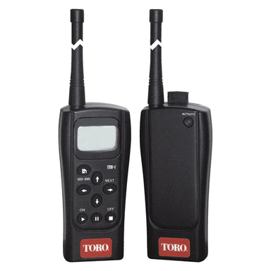 Handheld Toro TMR-1-KIT transmitter showing keypad and LCD display with ergonomic grip and removable belt clip.