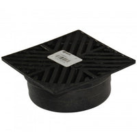 Installed view of black NDS square grate covering a 4-inch drainage fitting, illustrating low-profile design, rustproof foam.