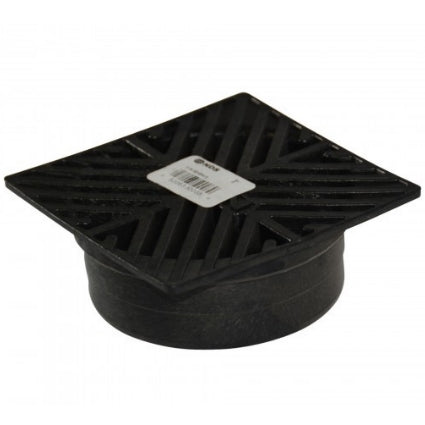 Installed view of black NDS square grate covering a 4-inch drainage fitting, illustrating low-profile design, rustproof foam.