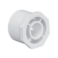 White Schedule 40 PVC reducer bushing, 2 inch spigot to 1-1/4 inch slip, front view on white background, molded fitting detail visible