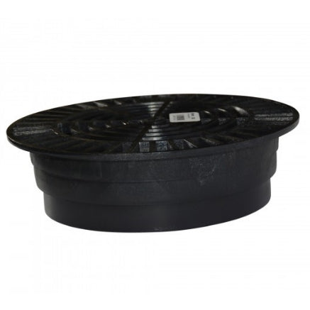 Installed view of NDS 10-inch black round drain grate (1040) capturing surface water while blocking leaves and debris from entering the drain.