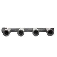Angled photograph of 1" PVC quad manifold female (1201-410) highlighting the threaded nut and FVCONN-style outlet connections for irrigation assemblies.
