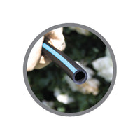 Close-up of Super Blue Flex tubing showing the blue stripe, flexible polyethylene construction, and coil edge for installer reference.