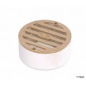 Top view of NDS 909B satin brass round drain grate mounted on PVC collar, showing grate pattern and brass screws clearly.