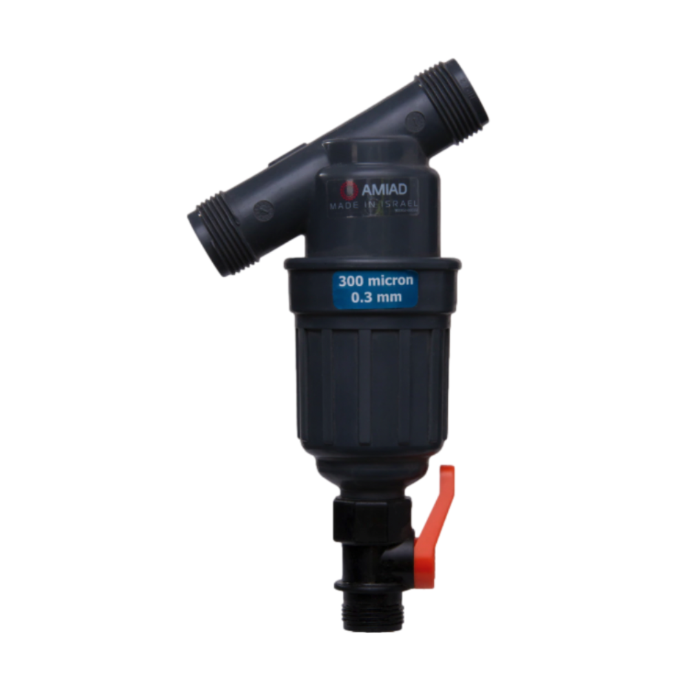 Close-up of AMAID 1-inch Tagline irrigation screen filter showing plastic housing, angled inlet, and orange plastic drain ball valve for flushing.