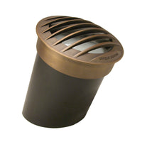 Apollo Star APST-12 in-ground well light in weathered brass with heavy-duty brass grate, shown in landscape.