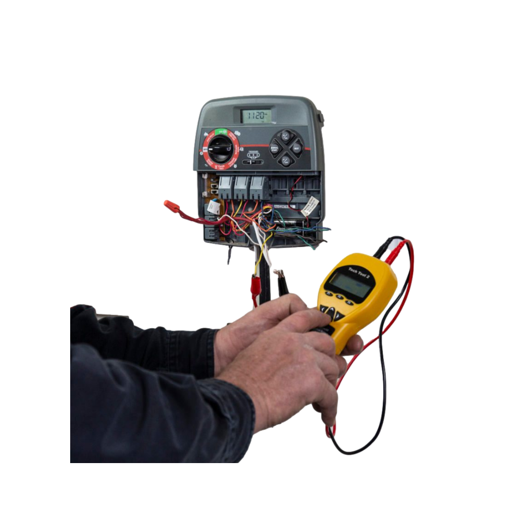 Angled view of Armada PRO50 tester highlighting built-in multimeter display, alligator clips, and interchangeable test lead connections.