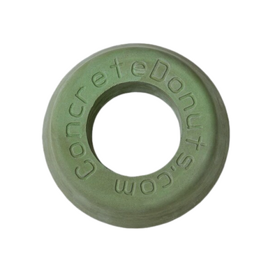 Green fiber-reinforced concrete donut sprinkler head protector (medium size) showing tapered outer edge and central opening.