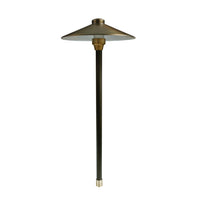 Centaurus 12-inch weathered brass path light on a 24-inch brass riser with a frosted cylindrical borosilicate lens, side profile view