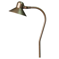 Excalibur brass path and area light with adjustable 5.45-inch bell shroud in weathered brass, shown mounted on a stabilizer stake and ground cable.