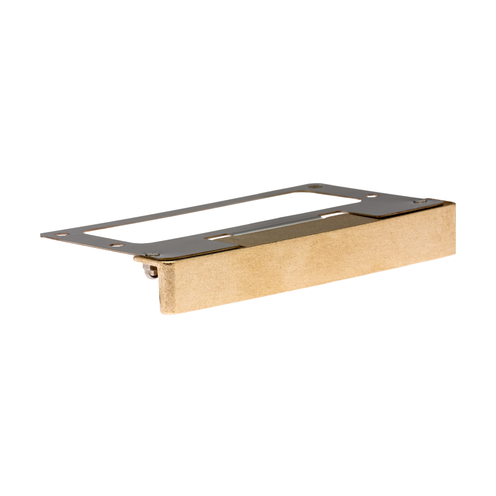 LF wall light in Natural Brass finish, die-cast brass housing and stamped faceplate, positioned beneath a capstone to highlight hardscape texture.