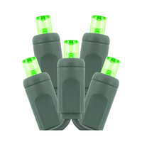 Green-wire 5mm LED light strand with green concave lenses stretched out to show even wide-angle illumination and socket spacing.