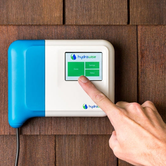Rear and side view of Hunter HC600I Hydrawise indoor controller showing terminal strip, wiring access, and compact wall-mount enclosure.