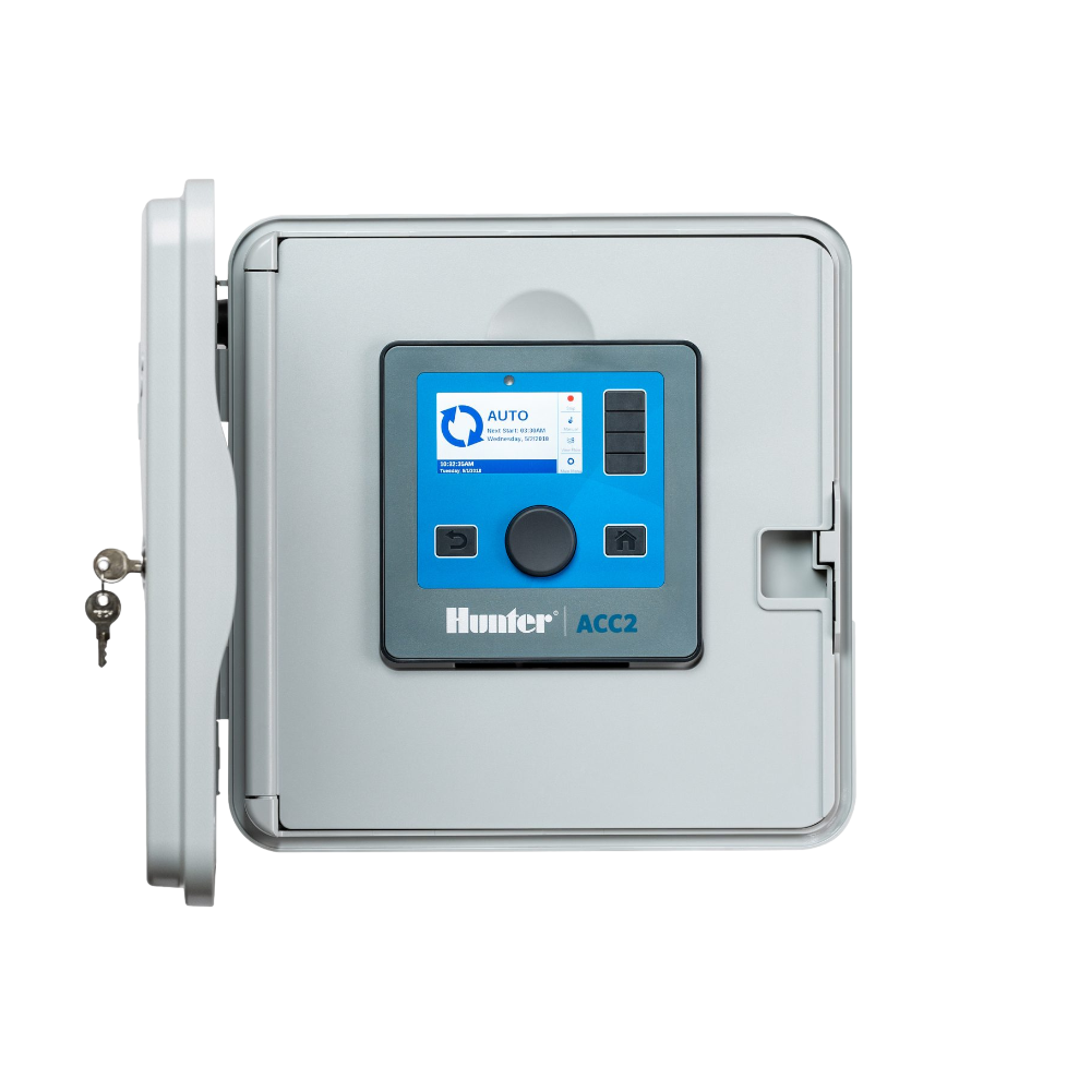 Hunter ACC2 commercial controller, gray metal wall-mount enclosure showing front panel, backlit LCD, terminal wiring connections, and model labeling.