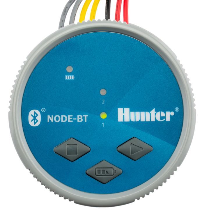 Hunter NODE-BT 2-station Bluetooth battery controller mounted on a valve box, side view with station wiring visible.