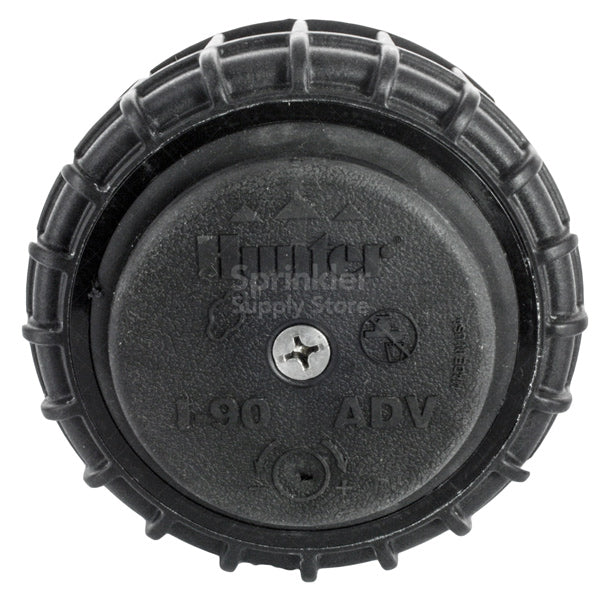 Front view of Hunter I-90-ADV 3-inch pop-up rotor installed in turf, showing the pop-up riser, nozzle openings, and low-profile rubber cover.