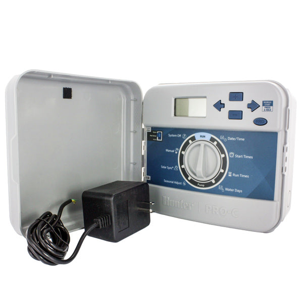 Front view of Hunter Pro-C PC-400i 4-station indoor irrigation controller showing LCD display, program dial, and button controls on plastic cabinet.