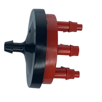 Red Rain Bird Xeri-Bug multi-outlet drip emitter showing six barbed outlet ports, compact pressure-compensating plastic housing, front view