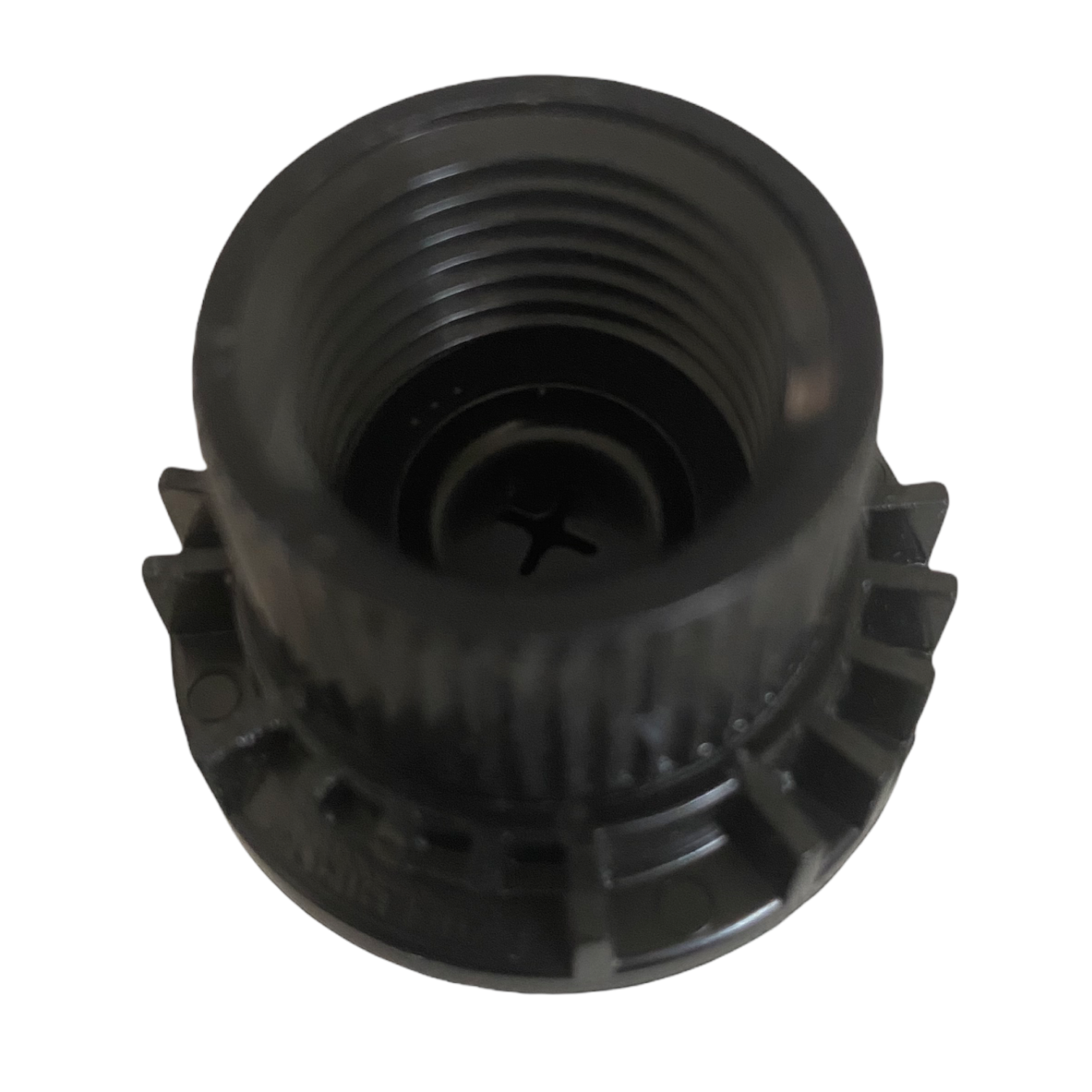 Close-up of Rain Bird XBT056 emitter top showing inlet and outlet positions and pressure-compensating element within the blue housing.