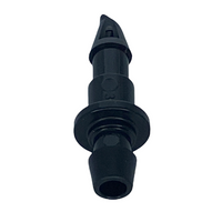 Angled view of Rain Bird XBF1CONN connector showing the small 1/4-inch barb, stem profile, and compact shape for discreet irrigation routing in landscapes.