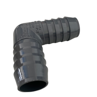 Top-down view of 1-inch PVC insert elbow with visible barbed insert ends and smooth PVC exterior for irrigation use.