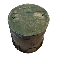 Front-angle view of Rain Bird VB7RND 7-inch round valve box showing black ribbed body and removable green lid, for irrigation access.