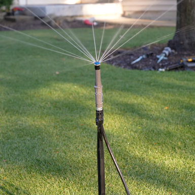 Top-down view of Princess Cut Lawn MP Rotator kit components: stakes, adjustable nozzles, brass fittings, MPTOOL, and tap timer.