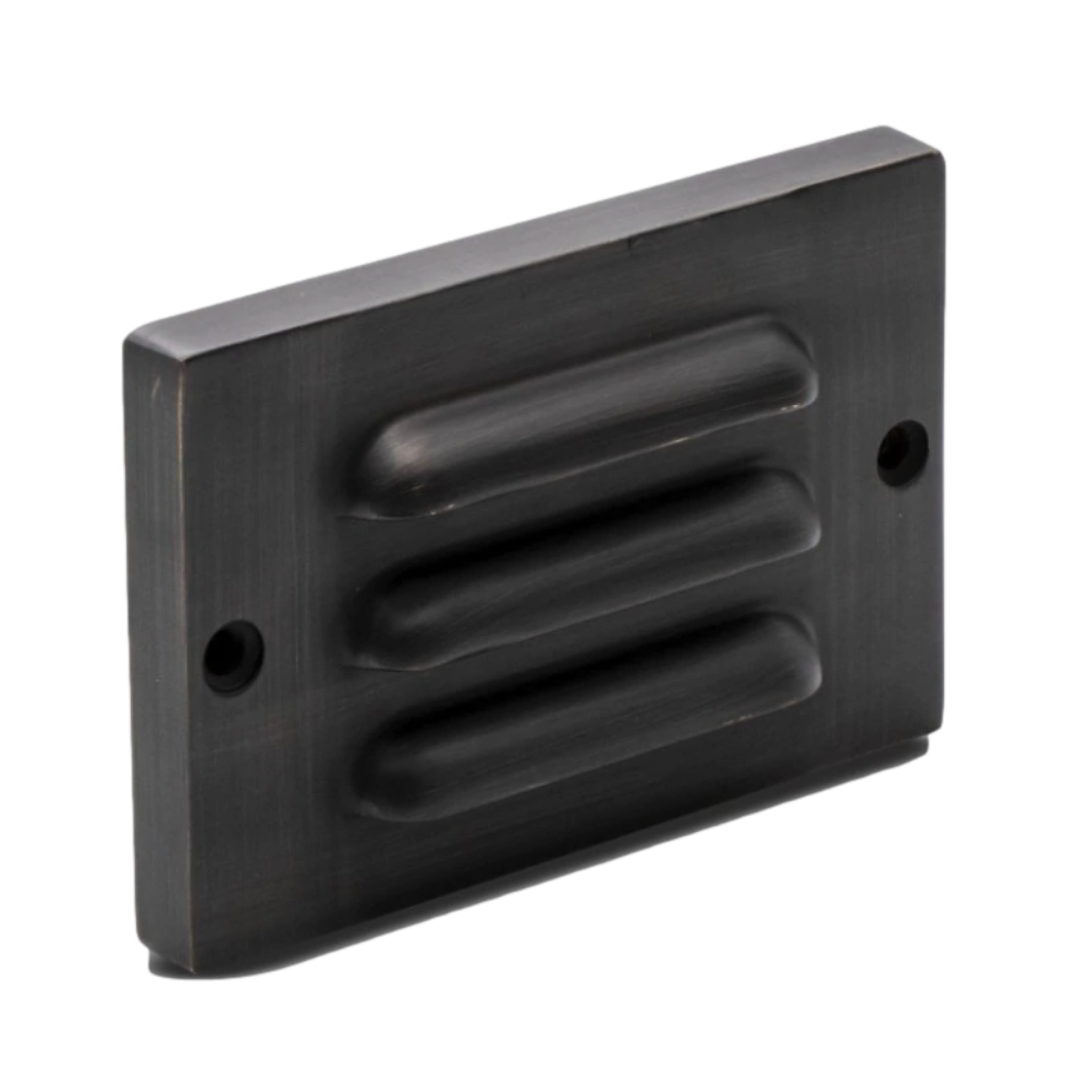 Pro-Trade SL1 4.5-inch surface-mounted LED step light with louvered antique-brass faceplate and warm 2700K illumination.