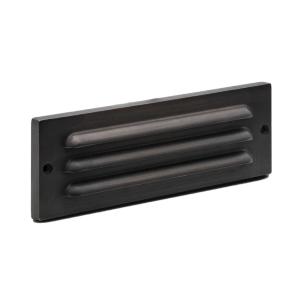Pro-Trade SL2 9-inch surface-mounted LED step light showing louvered antique brass faceplate and integrated LED.