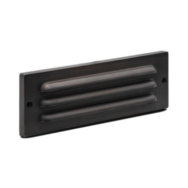 Pro-Trade SL2 9-inch surface-mounted LED step light showing louvered antique brass faceplate and integrated LED.