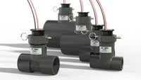 Lineup of Flomec QS200 ultrasonic flow meters in 1" to 4" Sch 80 PVC tee bodies showing size progression and patent marking.