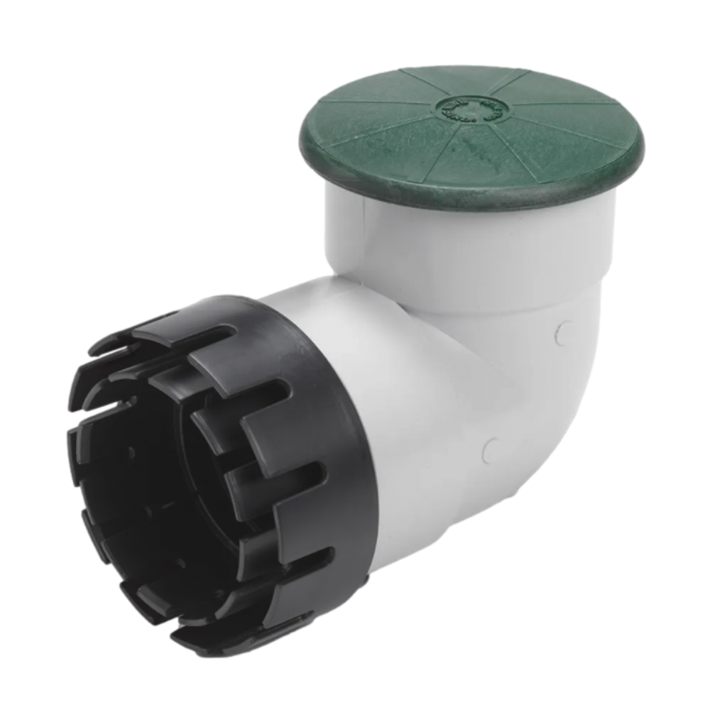 Green Rain Bird DPUV4EHUB drainage pop-up relief valve with spring-loaded cover, 4-inch PVC elbow and hub adapter, top view.