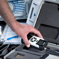 Close-up of Hunter ROAM XL transmitter showing large LCD, keypad and antenna, angled view highlighting ergonomic controls and display.