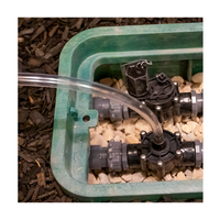 Angled close-up of Service Buddy demonstrating the tubing connection point and secure fitting for directing flushed water away from valve boxes during maintenance.