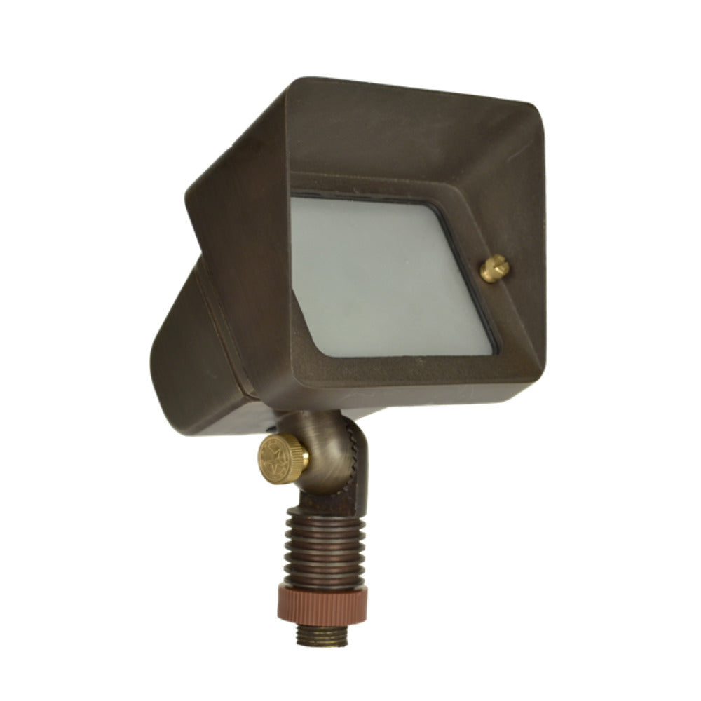 Weathered brass Unique Starburst wall-wash up light shown from an angle, highlighting machined brass body, adjustable knuckle, and lens set, outdoor stake mount visible.