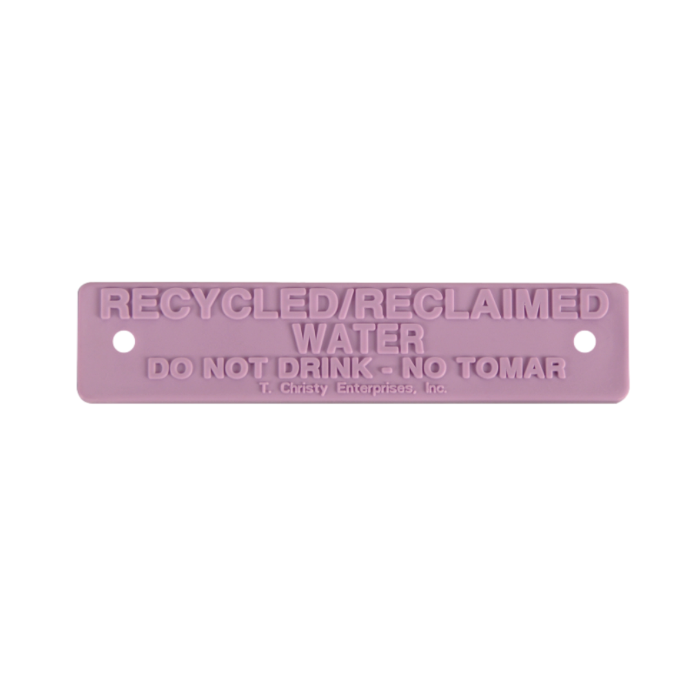 Purple rectangular valve box nameplate, 5.75 x 1.25 inches, printed 'RECYCLED / RECLAIMED WATER DO NOT DRINK - NO TOMAR', with two rivet holes for tamper-proof mounting.