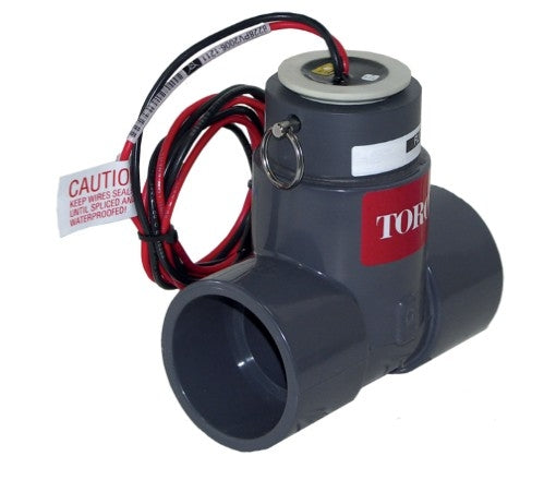 Toro TFS-075 3/4 inch plastic tee flow sensor, black potted sensor housing, PVC tee and two color-coded direct-burial leads visible, top-right view.