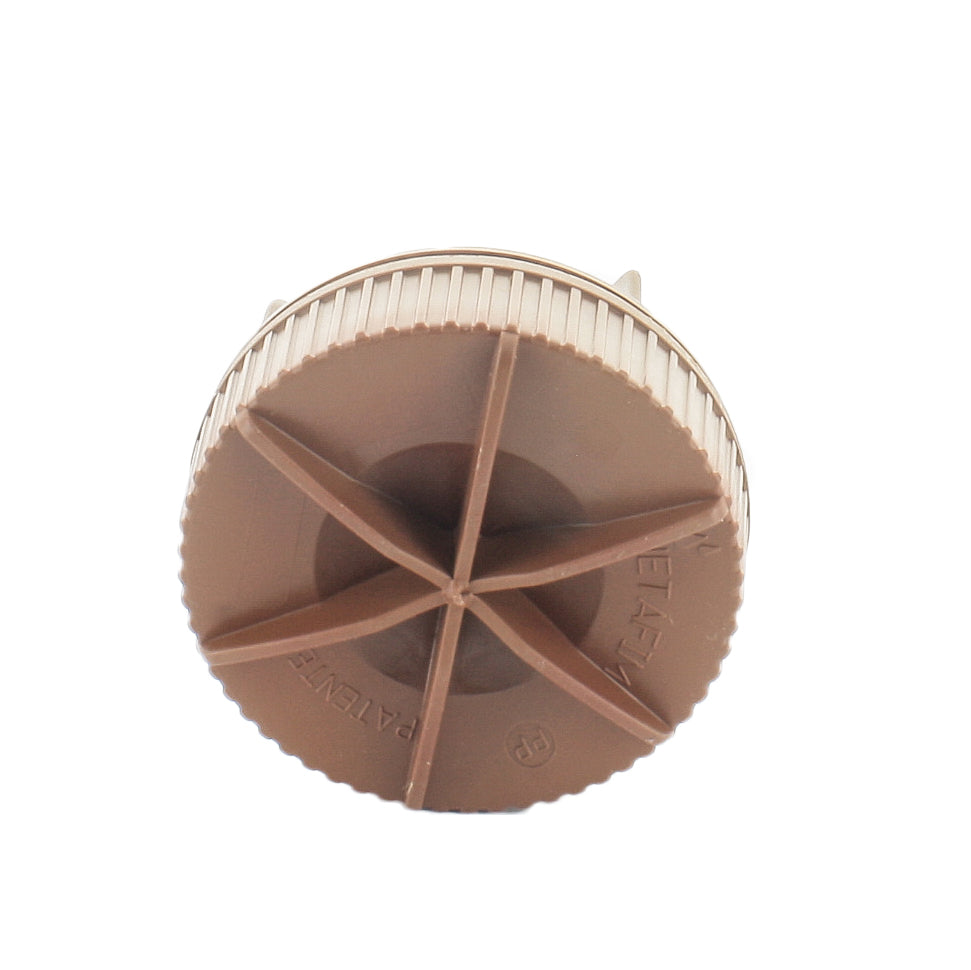 Netafim TL050MFV-1 flush valve installed on Techline drip tubing with visible MPT thread connection, brown valve body, outdoors.