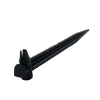 Rain Bird TS025 stake inserted through 1/4-inch drip tubing with emitter installed, illustrating secure hold at the plant root zone and tubing compatibility.