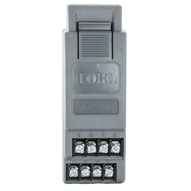 Front view of Toro TSM-8 8-station expansion module showing enclosure face, mounting slots, and labeling for module placement and connections (approx. 100 chars).