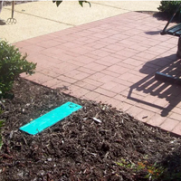 Top and side view of green WaterBox hose faucet enclosure depicting lid and compact footprint, suitable for placement near foundations or garden beds.